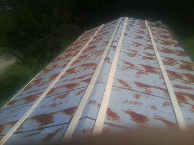 Rusted metal roof panels with new wood purlins before replacement — Storm Damage Roof Repair in Peacham by Roofing Brothers